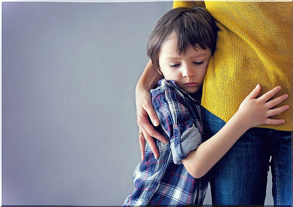 Child in fear hugging his mother