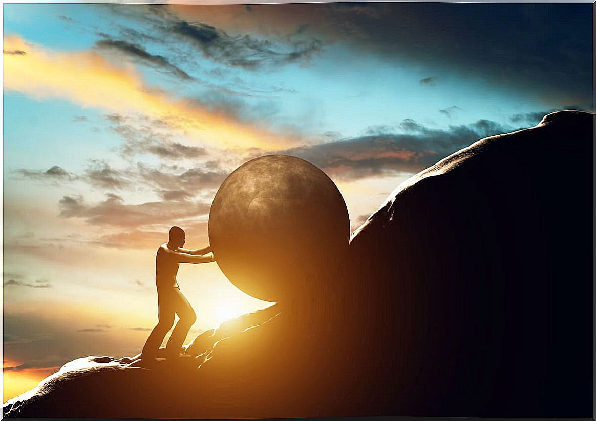 Man climbing a stone up a mountain representing motivational and self-improvement phrases