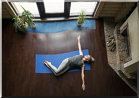 Woman doing supine twist pose