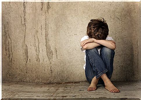 Lonely and sad child sitting on the floor as an effect of contempt