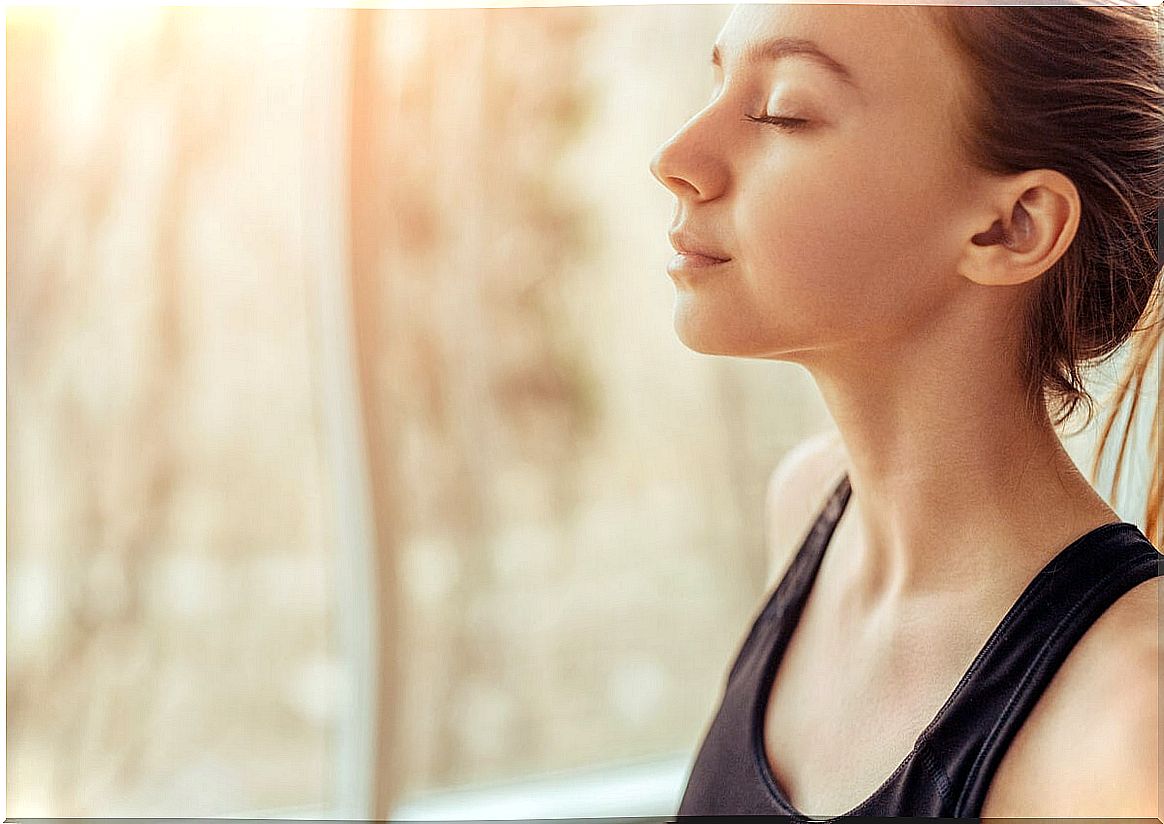 Woman with closed eyes thinking about emotional self control from anxiety