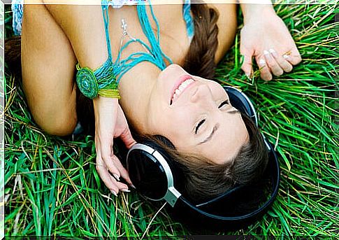 Woman listening to music while thinking about flowing with life