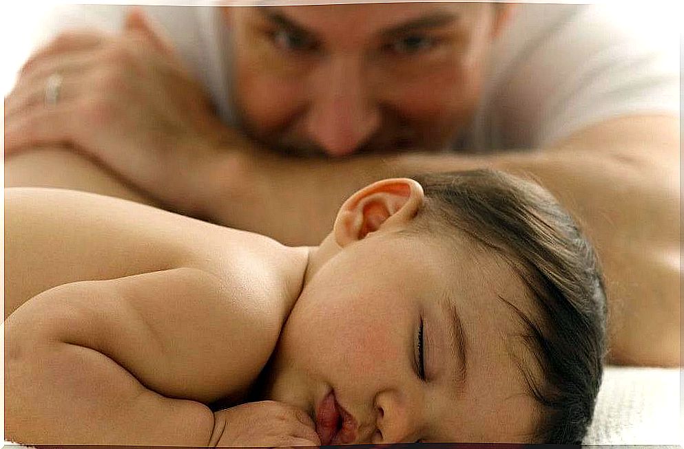 Father looking at a baby in subconscious phase