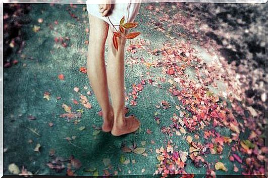 Feet of a girl surrounded by flowers