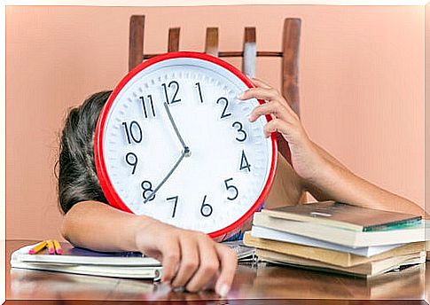 Boy with a clock and many homework