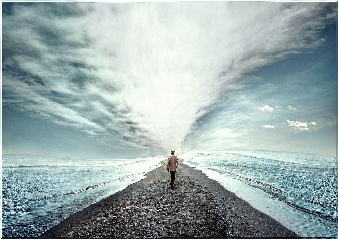 Man walking towards the sea representing how to become the person I want to be 