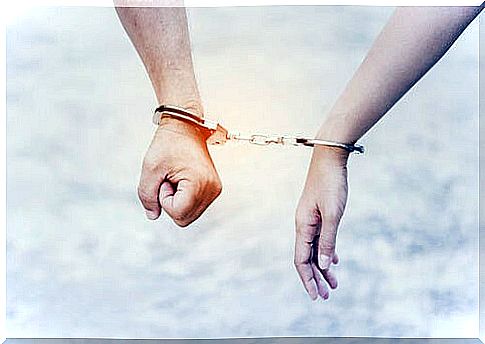 Chained hands symbolizing need for approval