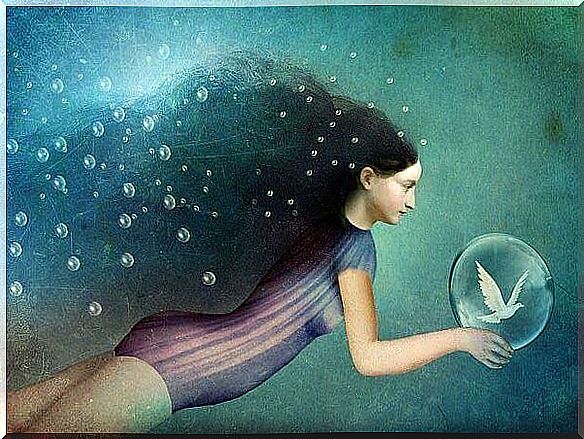 Woman underwater with a bubble