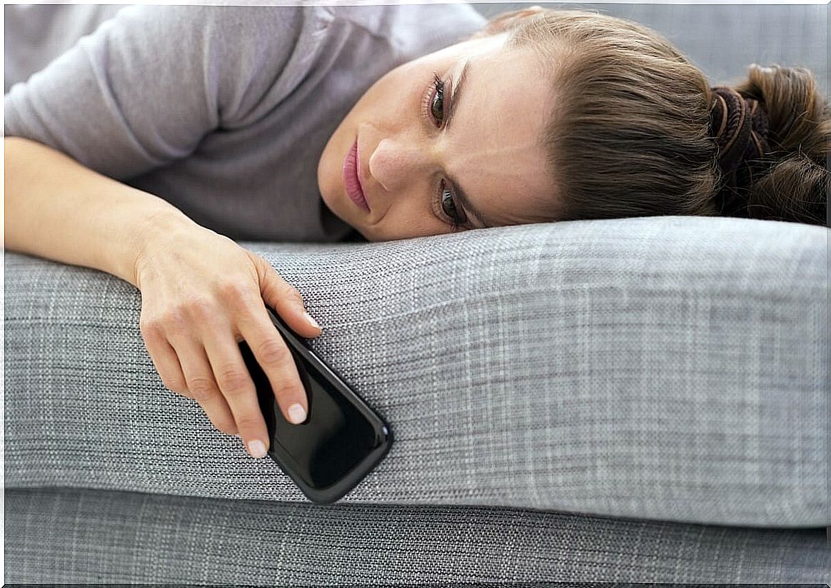 Woman looking at mobile worried