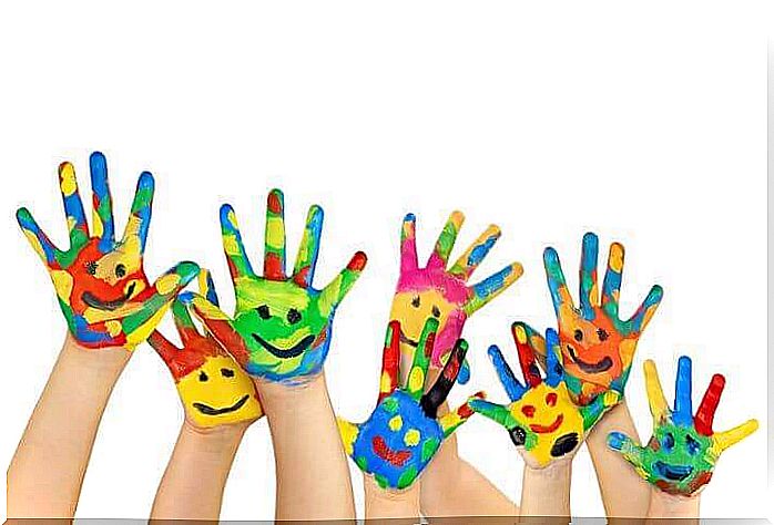 Children's hands painted with faces