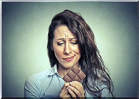 Woman with chocolate tablet in her hands wanting to eat it