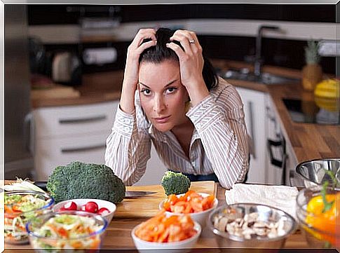 Nervous woman with a lot of food on the table