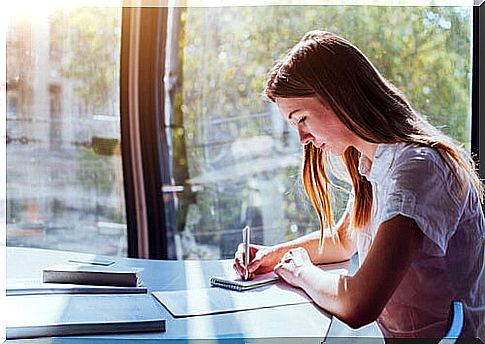 Woman writing new year goals