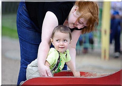 Mother with child on slide