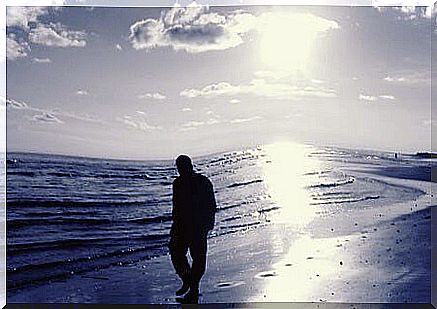 man walking along beach symbolizing the faces of narcissism