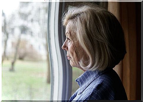 Senior woman looking at a window