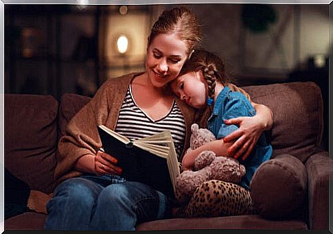 Mother with daughter reading a book