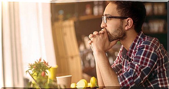 Man with glasses thinking about unconscious decisions