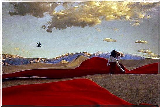 Woman in red dress in the desert