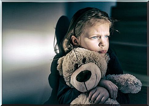 girl hugging bear symbolizing how parents affect our mental health 