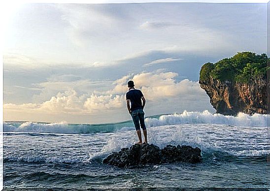 Man on the beach taking five minutes of silence