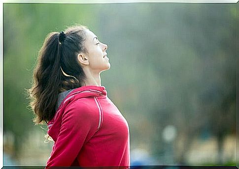 Athlete woman with closed eyes in the field 