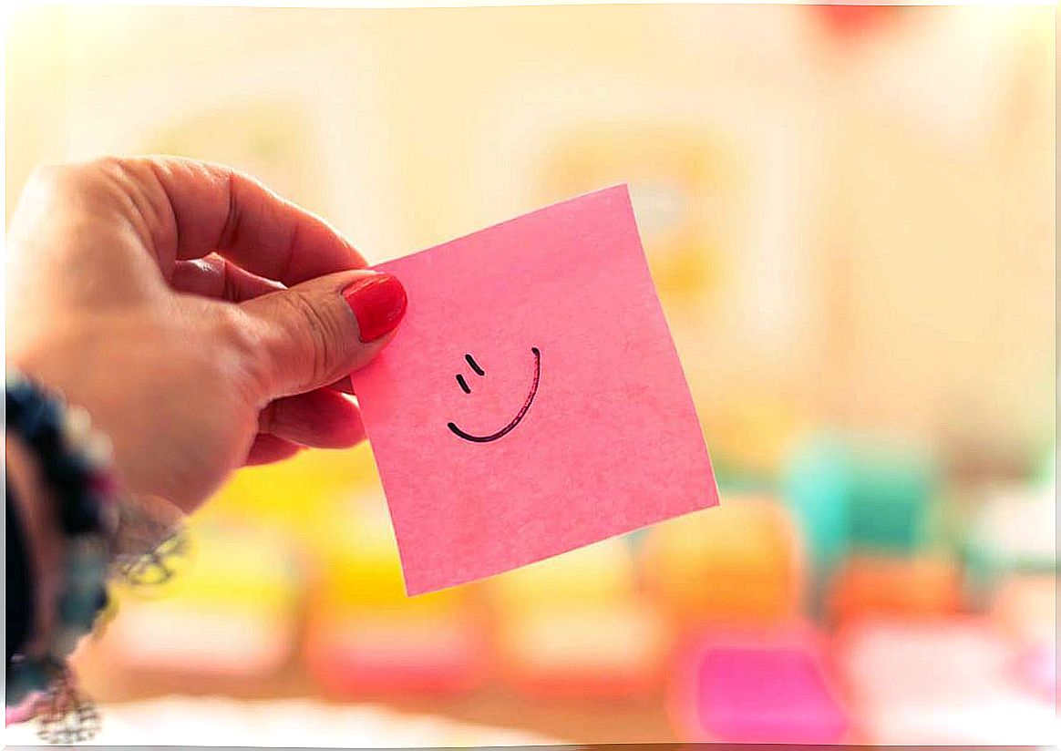 Smiling postit representing that thinking positive does not always work for us